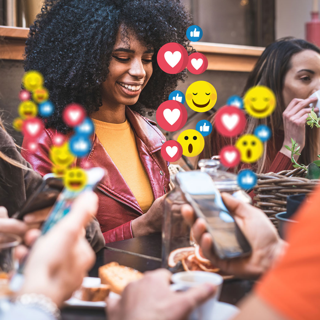 Black woman with others, drinking coffee, liking stuff on social media, and hearts and smiley emojis floating in the air.