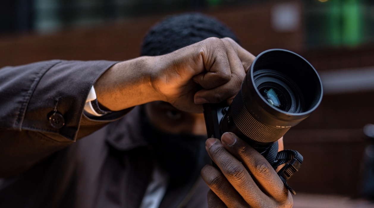 A black man using a camera